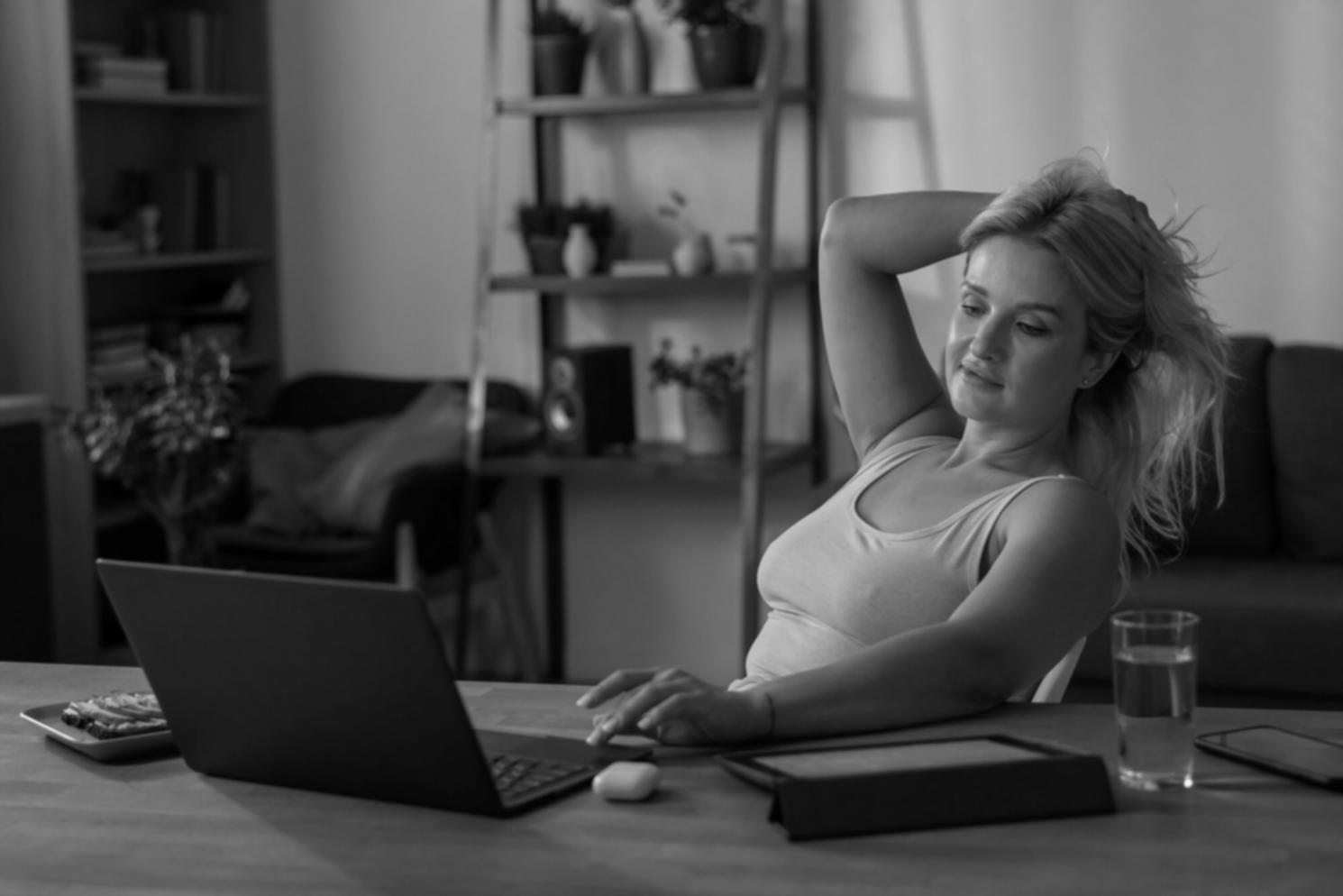 Person reviewing financial documents and making budget notes